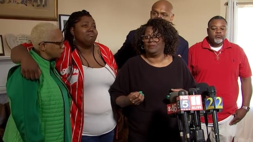 Sheryl Calhoun (third from left) talks to reporters about the death of her husband Charles Calhoun, who was shot and killed by Clayton County police outside the couple's Jonesboro home early March 23. She's joined by family members and Mawuli Davis, a Decatur attorney representing the family.