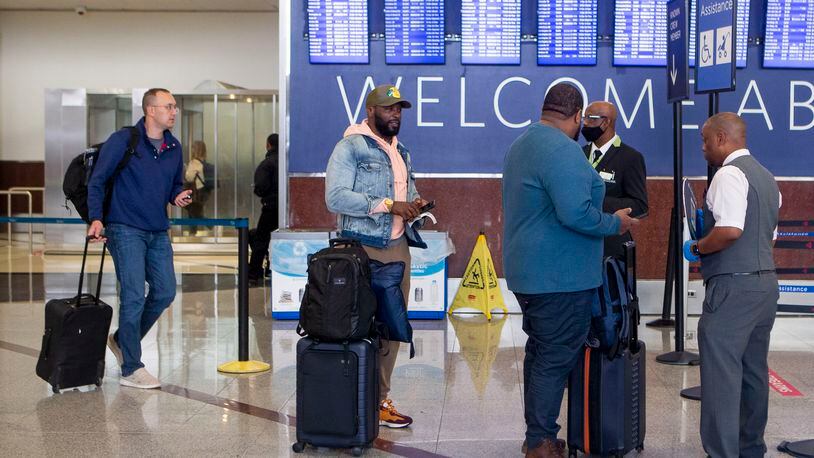 Travelers at Hartsfield-Jackson International Airport on Monday, December 12, 2022. AAA predicts a busy travel season during the holidays. CHRISTINA MATACOTTA FOR THE ATLANTA JOURNAL-CONSTITUTION