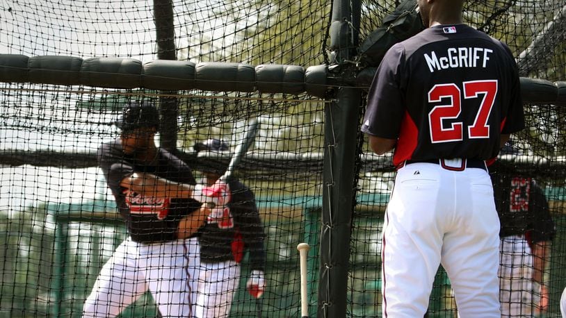 Former Brave Fred McGriff, right, watches as outfielder Jason Heyward bats during spring training in 2012, when McGriff was a guest instructor. Jason Getz jgetz@ajc.com