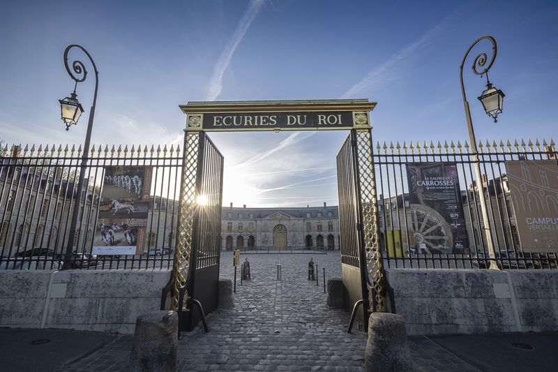 The entrance to the royal stables, in Versailles, Thursday, April 25, 2024. More than 340 years after the royal stables were built under the reign of France's Sun King, riders and horses continue to train and perform in front of the Versailles Palace. The site will soon keep on with the tradition by hosting the equestrian sports during the Paris Olympics. Commissioned by King Louis XIV, the stables have been built from 1679 to 1682 opposite to the palace's main entrance. (AP Photo/Aurelien Morissard)
