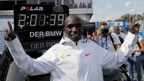 Eliud Kipchoge celebrates winning the 45th Berlin Marathon after setting  a world record.