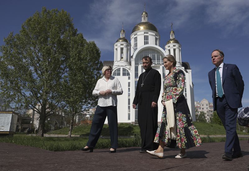 Britain's Sophie, Duchess of Edinburgh, and the Ambassador of the United Kingdom to Ukraine Martin Harris, right, visit the memorial to the victims of the Russian occupation in the town of Bucha, Ukraine, Monday, April 29, 2024. (Anatolii Stepanov/Pool via AP)