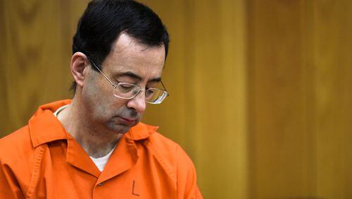 Larry Nassar looks down Monday, Feb. 5, 2018, on the third and final day of sentencing in Eaton County Court in Charlotte, Mich. He was sentenced to 40 to 125 years in prison. He was transferred to federal custody Thursday, Feb. 8, 2018.