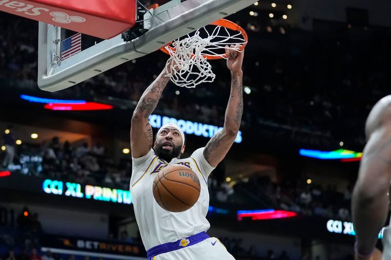 Los Angeles Lakers forward Anthony Davis slam dunks in the first half of an NBA basketball game against the New Orleans Pelicans in New Orleans, Sunday, April 14, 2024. (AP Photo/Gerald Herbert)