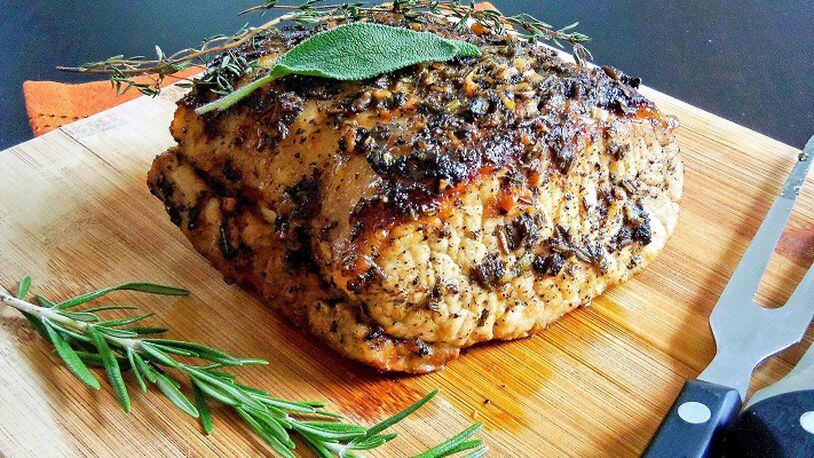 Herb-crusted pork loin is a juicy alternative for Thanksgiving. (Dana Cizmas/Pittsburgh Post-Gazette/TNS)