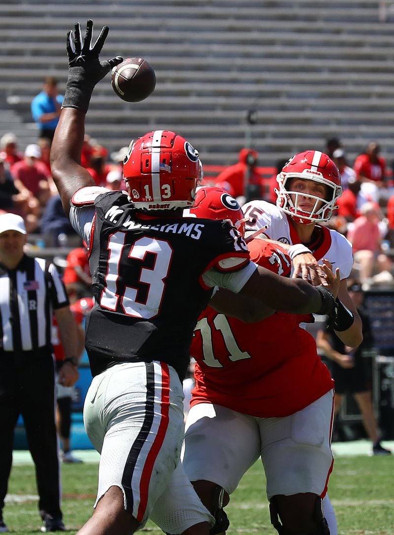 041324 Athens: Defensive lineman Mykel Williams deflects a pass by quarterback Carson Beck during the G-Day game on Saturday, April 13, 2024.  Curtis Compton for the Atlanta Journal Constitution