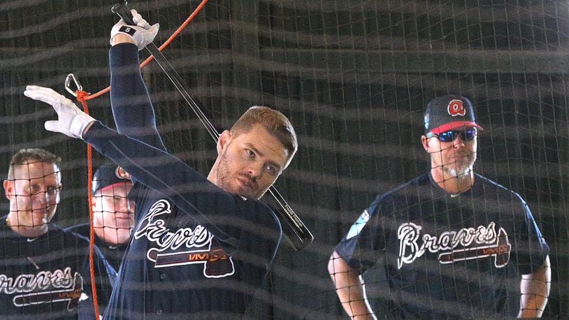 Braves first baseman Freddie Freeman takes swings in the batting cage as former teammate and recently elected Hall of Fame third baseman Chipper Jones watches at the team’s spring training complex in Lake Buena Vista, Fla.
