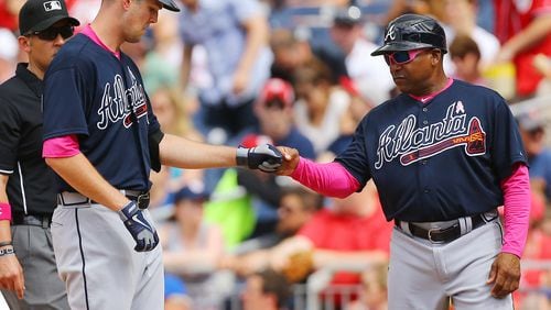 Braves pitcher Alex Wood gets a fist pump from first base coach Terry Pendleton after hitting his third single in the game against the Nationals during a baseball game on Sunday, May 10, 2015, at Nationals Park in Washington, D.C. Curtis Compton / ccompton@ajc.com