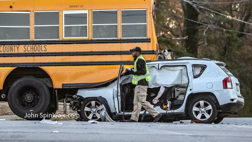 An SUV crashed into the back of a DeKalb County school bus early Thursday morning. One person in the SUV was critically injured, and two students aboard the bus were medically evaluated.