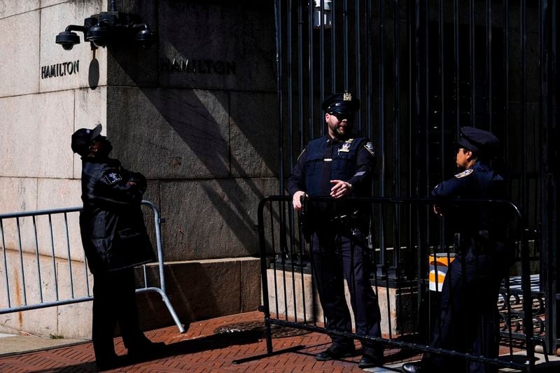 Police officers and a security guard stand outside Columbia University's Hamilton Hall, Wednesday, May 1, 2024, in New York. (AP Photo/Julia Nikhinson)
