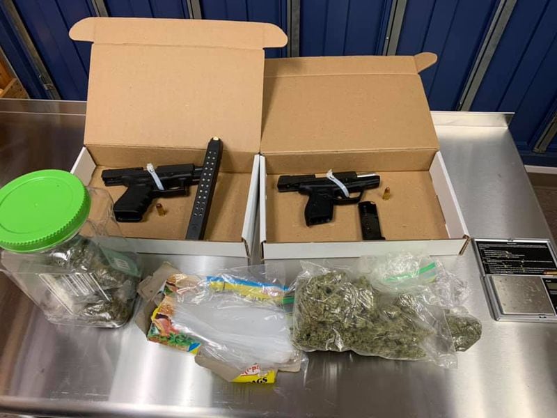 Officers recovered two guns from the vehicle and a felony amount of marijuana, police said.