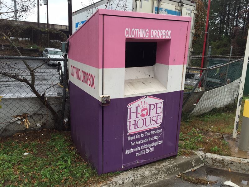 Two of NSPIRE Outreach’s clothing donation bins, including this one in College Park, did not have legally-required language on the front. JOHNNY EDWARDS / JREDWARDS@AJC.COM