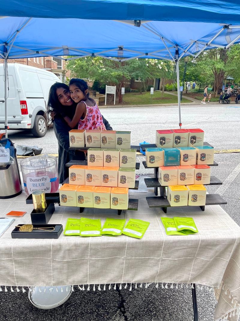 Poorvi Chordia and her youngest daughter, Nitya, are seen at their booth at the Morningside Farmers Market. Courtesy of Herbs & Kettles