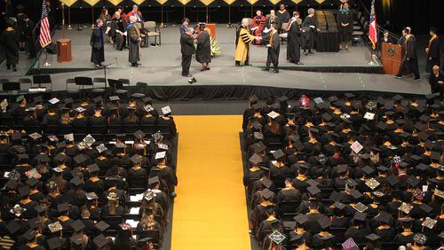 May 10, 2017, Atlanta, Georgia - Students along with their family and friends from Kennesaw State University in the College of Humanities and Social Sciences attend their Commencement ceremony to graduate from the university in Kennesaw, Georgia, on May 10, 2017. Two new reports show the state of Georgia is committing a smaller percentage of money for college costs. (HENRY TAYLOR / HENRY.TAYLOR@AJC.COM)