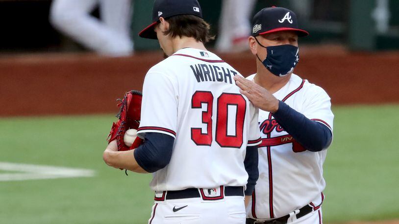 Braves manager Brian Snitker, right, removes starting pitcher Kyle Wright and gives him a pat of support. (Curtis Compton / Curtis.Compton@ajc.com)