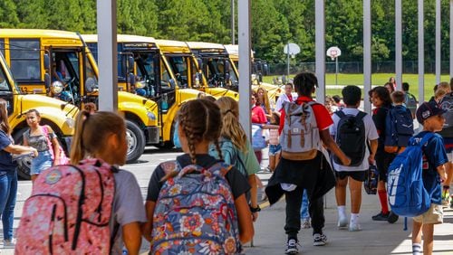 School bus riders finish their school day and start their ride home in Cherokee County on Thursday, Sept 2, 2021.  (Jenni Girtman for The Atlanta Journal-Constitution)