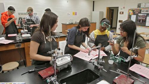 Students work together on their chemistry project in a Dacula High School AP chemistry class. (Bob Andres / AJC file photo)