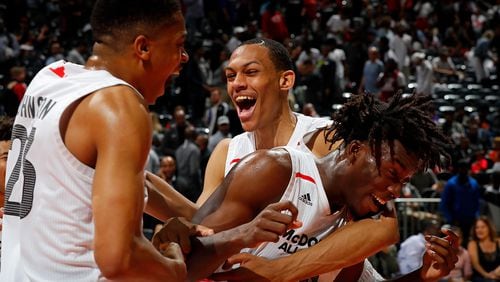 Nassir Little #10 of Orlando Christian Prep is congratulated by teammates Keldon Johnson #23 of Oak Hill Academy and Darius Bazley #15 of Princeton High School after he won the MVP trophy in the 2018 McDonald's All American Game at Philips Arena on March 28, 2018 in Atlanta, Georgia.  (Photo by Kevin C. Cox/Getty Images)