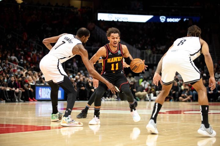 The Hawks' Trae Young (11) dribbles the ball during a game between the Atlanta Hawks and the Brooklyn Nets at State Farm Arena in Atlanta, GA., on Friday, December 10, 2021. (Photo/ Jenn Finch)