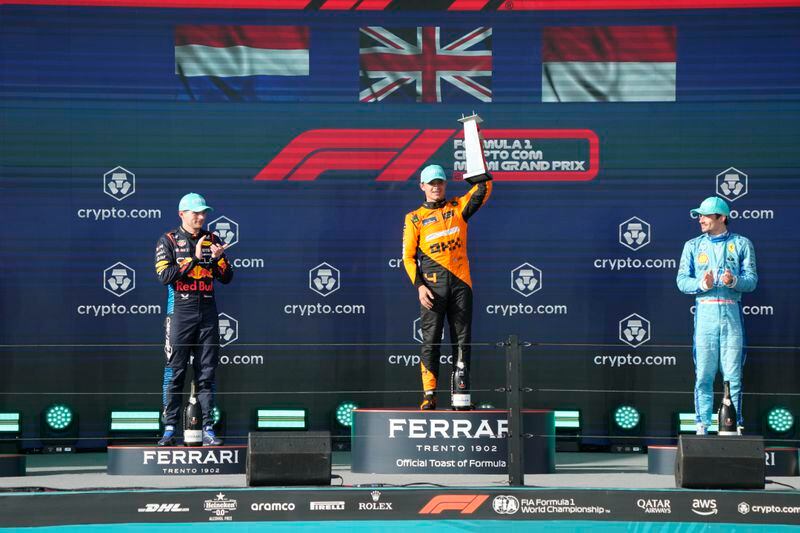 McLaren driver Lando Norris, of Britain, center, holds up his trophy after winning the Formula One Miami Grand Prix auto race at the Miami International Autodrome, Sunday, May 5, 2024, in Miami Gardens, Fla. Second place winner, Red Bull driver Max Verstappen, of the Netherlands, left, and third place winner Ferrari driver Charles Leclerc, of Monaco, stands at right. (AP Photo/Wilfredo Lee)