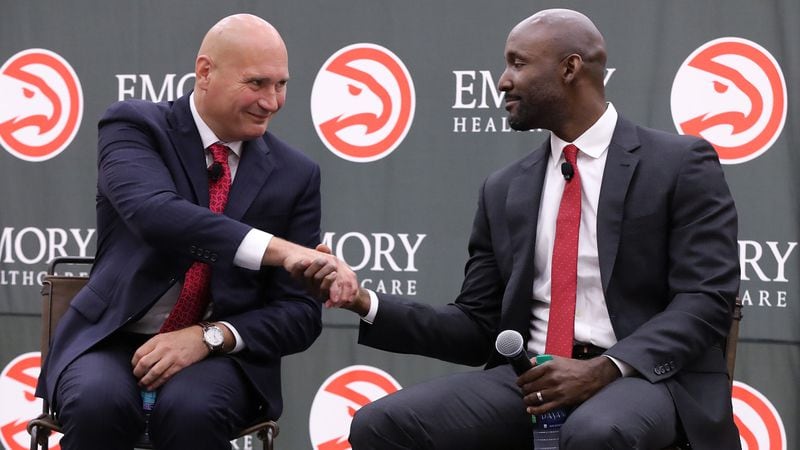 Atlanta Hawks general manager Travis Schlenk (left) introduces Lloyd Pierce as the 13th full-time coach in the history of the NBA franchise on Monday, May 14, 2018, in Atlanta. (Curtis Compton/ccompton@ajc.com)