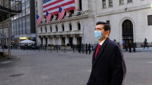 An unidentified man wears a facial mask near the New York Stock Exchange, owned by Atlanta-based Intercontinental Exchange. This week, ICE made a $11 billion bet on a California company that has reaped large profits as finance moves online during the pandemic. (Luiz C. Ribeiro/New York Daily News/TNS)