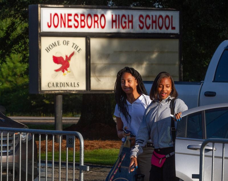 Zadyah Royster (L) and Ahania Gover are dropped off at Jonesboro High School on the first day of school Monday, August 6, 2018, in Jonesboro.