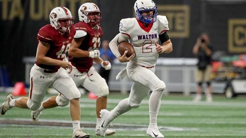 Walton quarterback Austin Kirksey (2) runs for a first down in the second half against Mill Creek during the Corky Kell Classic game Saturday, Aug. 18, 2018, at Mercedes-Benz Stadium in Atlanta.