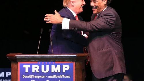 Donald Trump gets a hug from Bruce Levell. AJC/Curtis Compton.