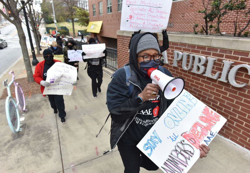 Atlanta Public Schools teachers march around the district's downtown  headquarters to push for a delay in reopening school buildings on Jan. 16, 2021.  Hyosub Shin /AJC FILE PHOTO