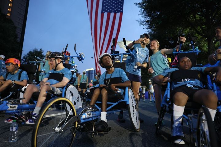 Racers in the Shephard Wheelchair Division prepare for the start of the 54th running of The Atlanta Journal-Constitution Peachtree Road Race in Atlanta on Tuesday, July 4, 2023.   (Arvin Temkar / Arvin.Temkar@ajc.com)