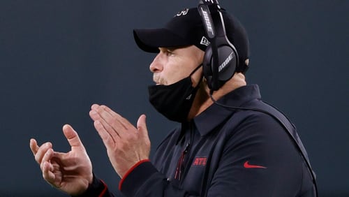 Falcons coach Dan Quinn encourages his team during the second half of Monday's loss at Green Bay. (AP/Tom Lynn)