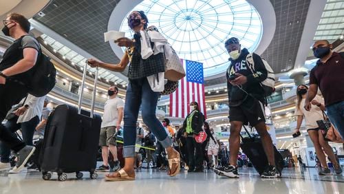 Crowds swelled in Hartsfield-Jackson International Airport’s domestic atrium on July 2, 2021 with travelers heading out on the Fourth of July holiday weekend. John Spink / John.Spink@ajc.com)