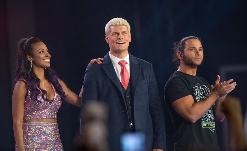 All Elite Wrestling’s executive vice president Cody Rhodes, center, and chief brand officer Brandi Rhodes, left, stand beside one-half of tag team titans the Young Bucks, who were instrumental in creating AEW. (Tom Donoghue/Courtesy of AEW)