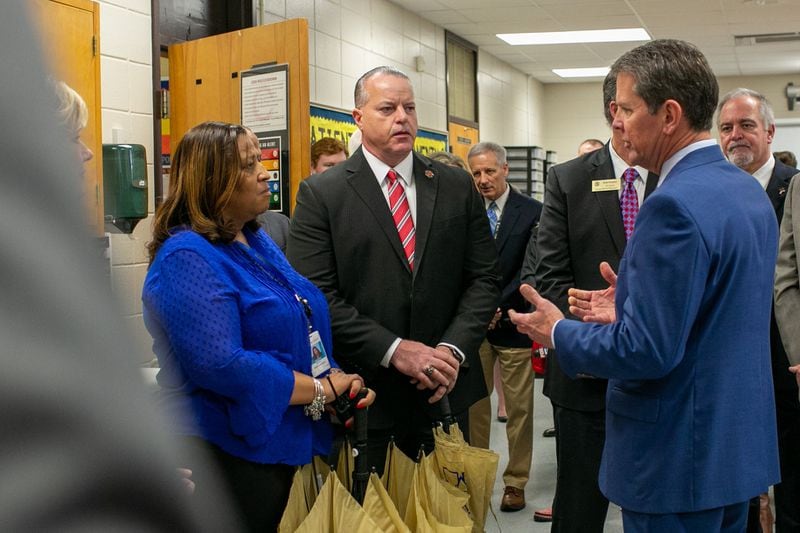 Gov. Brian Kemp speaks to McEachern High School Principal Regina Montgomery and Cobb County Superintendent Chris Ragsdale during a tour of McEachern High School in Powder Springs on Thursday, Feb. 13, 2020. 
