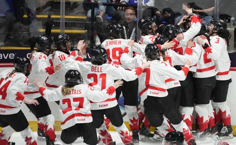 Canada players celebrate their overtime win over the United States during their gold medal game at the women's world hockey championships in Utica, N.Y., Sunday, April 14, 2024. (Christinne Muschi/The Canadian Press via AP)