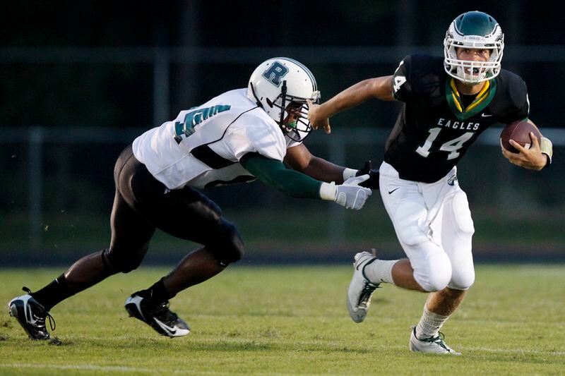 Collins Hill QB Taylor Heinicke (right) runs against Roswell in 2010.