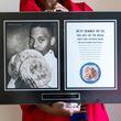 Deborah Evans poses with a picture of her late husband, chef Darryl Evans, at her home in Stone Mountain on Thursday, February 15, 2024. (Arvin Temkar / arvin.temkar@ajc.com)