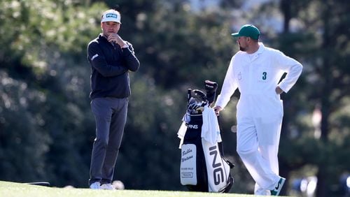 Bubba Watson talks with his caddie Gabriel Sauer as he prepares for his second shot on the first hole during the second round of the Masters at Augusta National Golf Club on Friday, April 8, 2022, in Augusta. (Curtis Compton / Curtis.Compton@ajc.com)