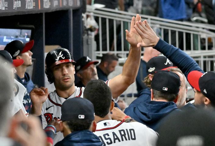 Atlanta Braves first baseman Matt Olson (28) is greeted in the dugout after scoring against the Philadelphia Phillies during the sixth inning of game two of the National League Division Series at Truist Park in Atlanta on Wednesday, October 12, 2022. (Hyosub Shin / Hyosub.Shin@ajc.com)