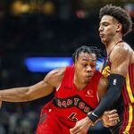 Hawks forward Jalen Johnson defends against the drive of Toronto's Scottie Barnes during Friday's game at State Farm Arena. The Raptors defeated the Hawks 123-121.