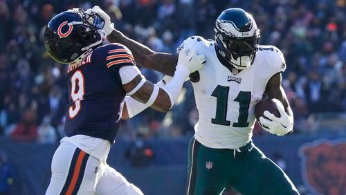 Philadelphia Eagles' A.J. Brown, right, tries to get past Chicago Bears' Jaquan Brisker during the first half of an NFL football game against the Chicago Bears, Sunday, Dec. 18, 2022, in Chicago. (AP Photo/Nam Y. Huh)