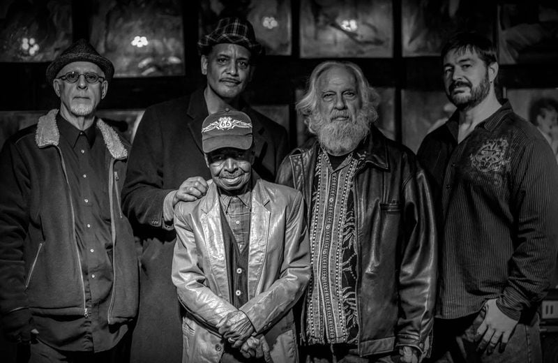 Members of Uncle Sugar (back row, from the left: Stephen Talkovich, Larry Griffith, Ross Pead and Jon Schwenke) pose with the diminutive blues pianist Eddie Tigner (foreground), with whom they performed for many years. Courtesy of Drew Stawin