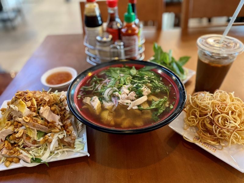 This order at Com Ga Houston includes chicken salad, chicken with pho, iced coffee and a tray of slivered banana flowers. Wendell Brock for The Atlanta Journal-Constitution