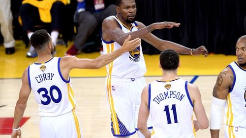Kevin Durant and the Golden State Warriors react in Game 2 of the 2017 NBA Finals against the Cleveland Cavaliers at ORACLE Arena on June 4, 2017 in Oakland, California.  (Photo by Thearon W. Henderson/Getty Images)