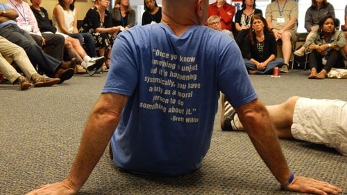 Jonathan Rapping, his back to the camera, sits with a group of public defenders and supervisors during a recent training and development session. Rapping is the founder of the non-profit Gideon’s Promise. Contributed by Gideon’s Promise