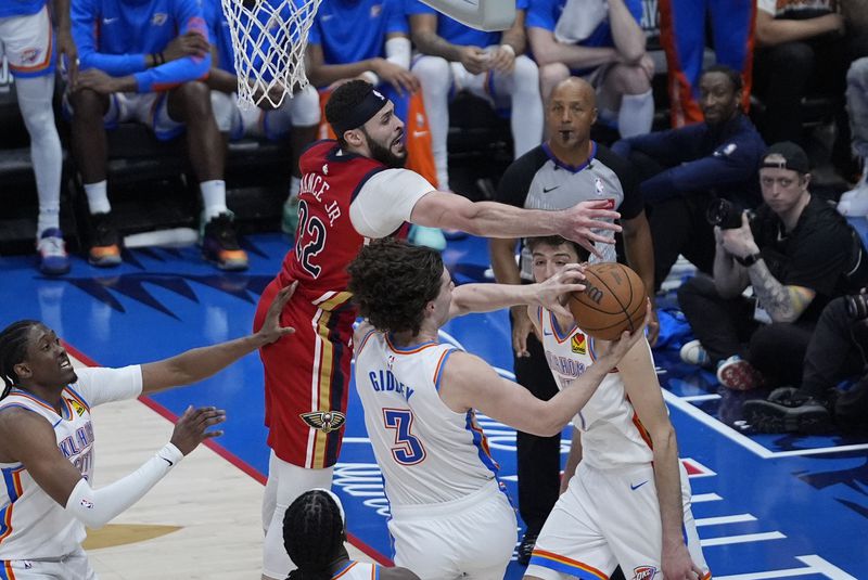 Oklahoma City Thunder guard Josh Giddey (3) pulls down a rebound against New Orleans Pelicans forward Larry Nance Jr. (22) in the second half of Game 3 of an NBA basketball first-round playoff series in New Orleans, Saturday, April 27, 2024. The Thunder won 106-85. (AP Photo/Gerald Herbert)