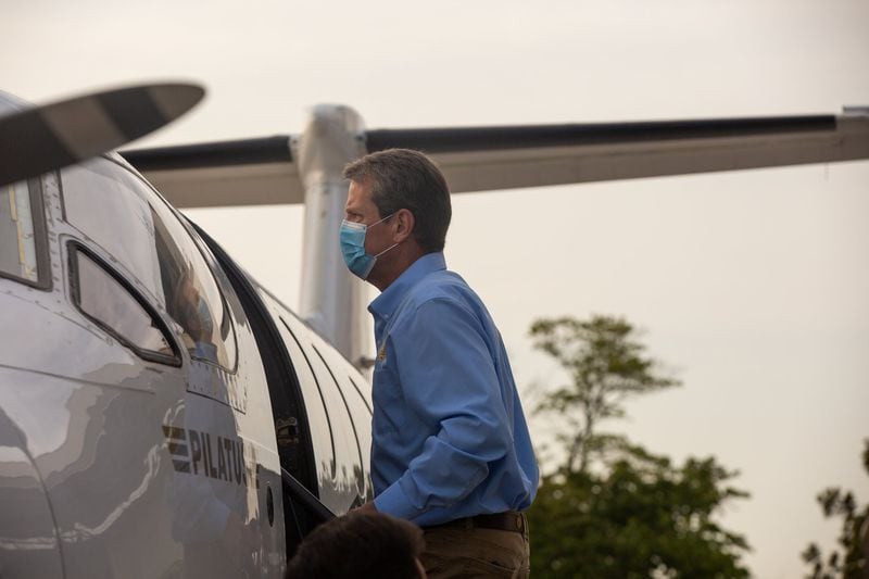 Georgia Gov. Brian Kemp boards a plane at the Peachtree DeKalb Airport in Atlanta on July 1, 2020. Kemp and Georgia Department of Public Health Commissioner Dr. Kathleen Toomey took part in a “Wear a Mask” Flyaround Tour of Georgia, encouraging Georgians to follow the guidance of public health officials to stop the spread of COVID-19. (Rebecca Wright for The Atlanta Journal-Constitution)