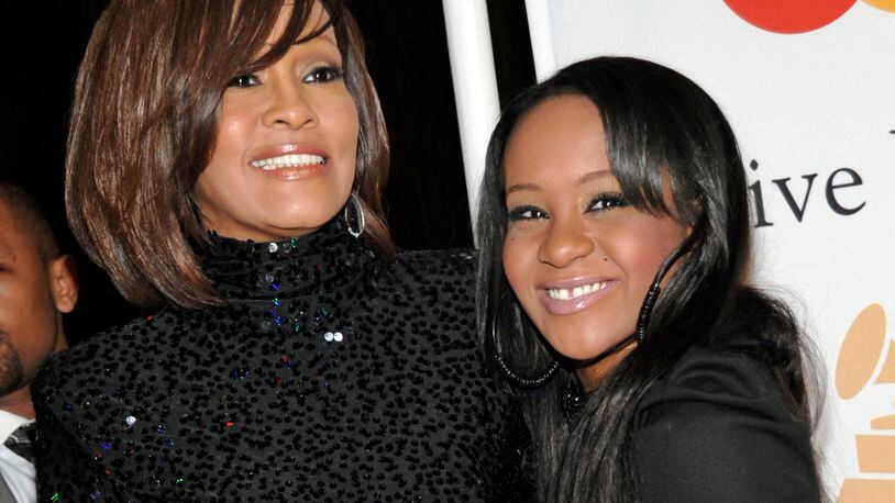 FILE - In this Feb. 12, 2011 file photo, singer Whitney Houston, left, and her daughter Bobbi Kristina arrive at the Pre-Grammy Gala & Salute to Industry Icons with Clive Davis honoring David Geffen in Beverly Hills, Calif. The daughter of singers Whitney Houston and Bobby Brown died at the age of 22 on July 26, 2015, in hospice care six months after she was found face-down in a bathtub. (AP Photo/Dan Steinberg)
