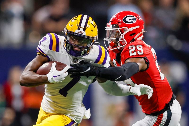 LSU Tigers wide receiver Kayshon Boutte (7) breaks away from Georgia Bulldogs defensive back Christopher Smith (29) for a touchdown during the first half of the SEC Championship Game at Mercedes-Benz Stadium in Atlanta on Saturday, Dec. 3, 2022. (Jason Getz / Jason.Getz@ajc.com)